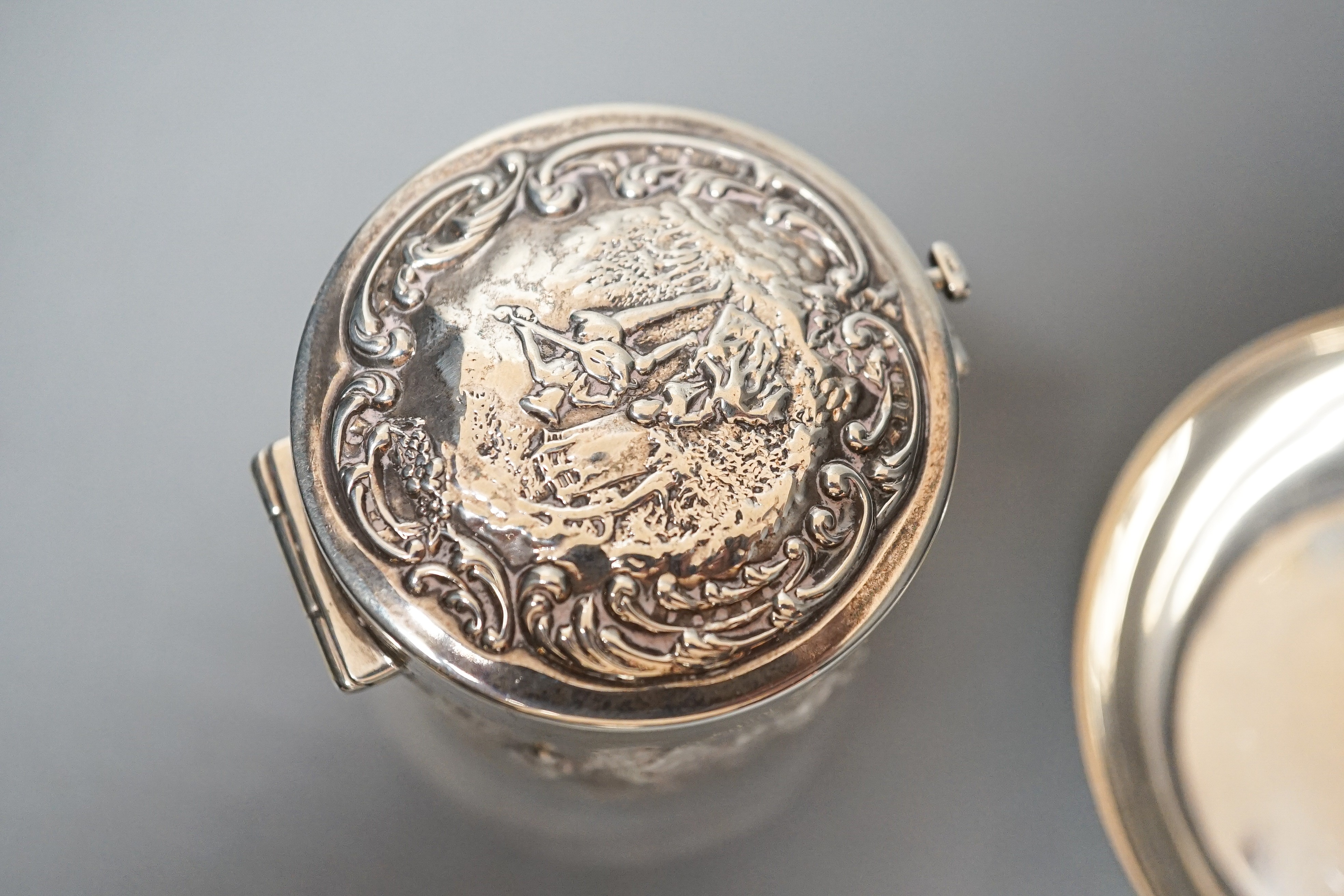 A George V silver taste vin, Tessiers Ltd, London, 1924, 10.2cm, together with an Edwardian embossed silver travelling hair curling tongs warmer, Levy & Salaman, Birmingham, 1901, 52mm (lacking warmer?).